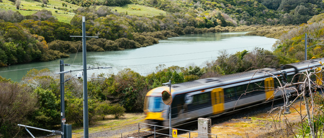 Countryside with a river and a train in the foreground.