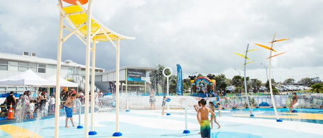 Children playing in an outdoor water playground.